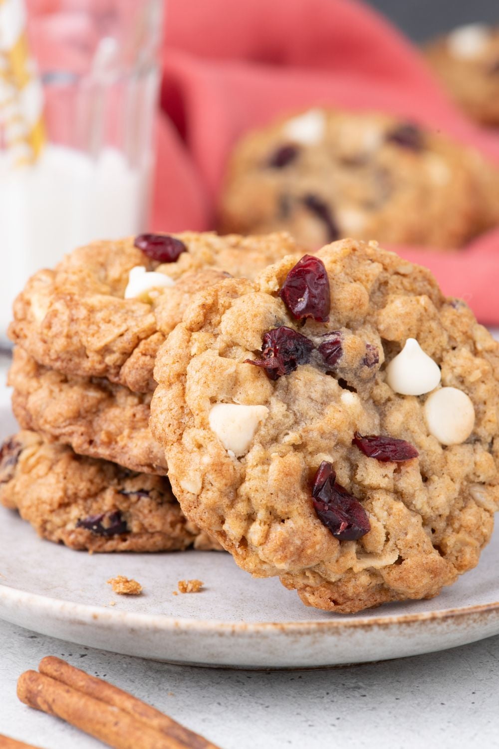 White Chocolate Cranberry Oatmeal Cookies on plate with a cookie tipped on the side