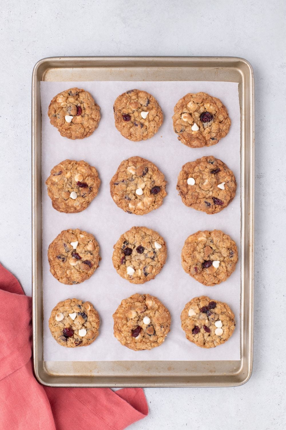 White Chocolate Cranberry Oatmeal Cookies on a baking sheet sitting on table