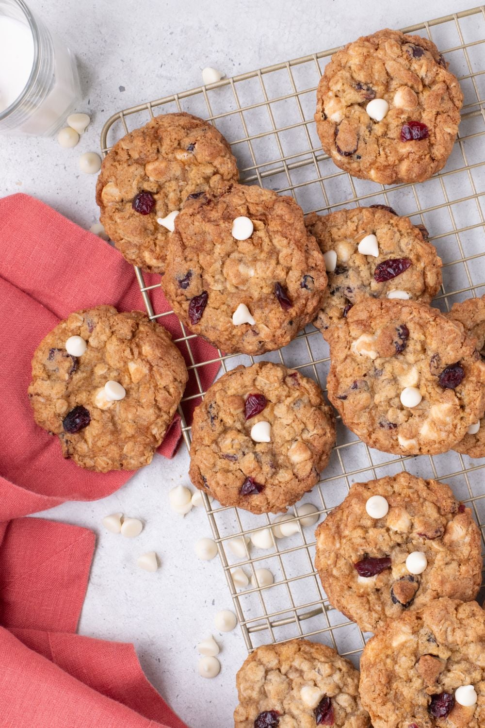 White Chocolate Cranberry Oatmeal Cookies on a cooling rack spread out around table