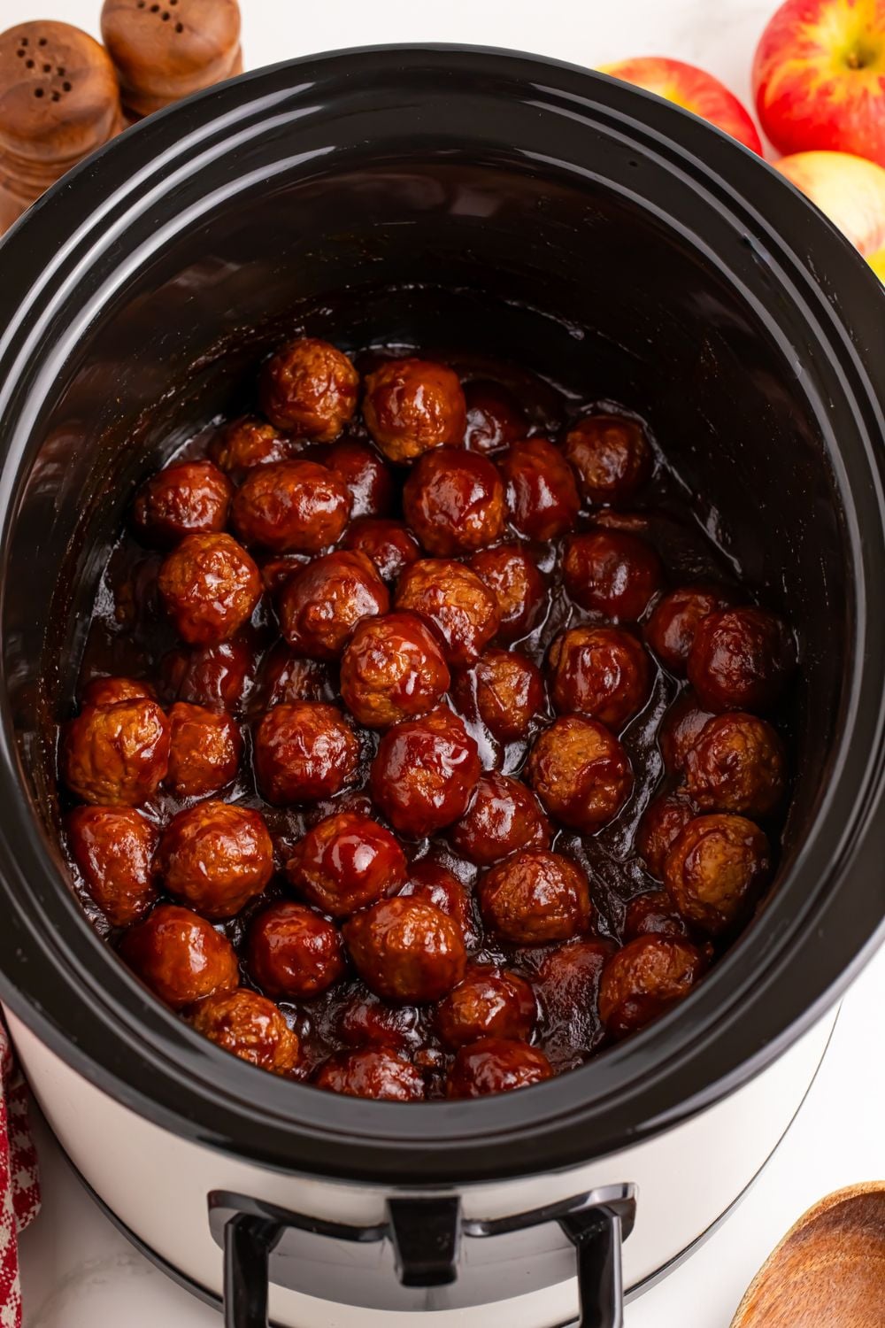 overhead shot of cooked slow cooker apple butter meatballs in it