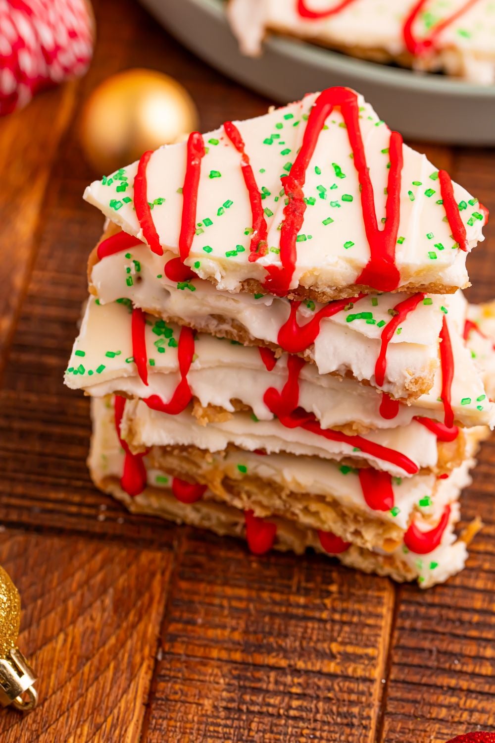 Christmas Tree Crack stacked on wooden table with Christmas decor behind it on table 