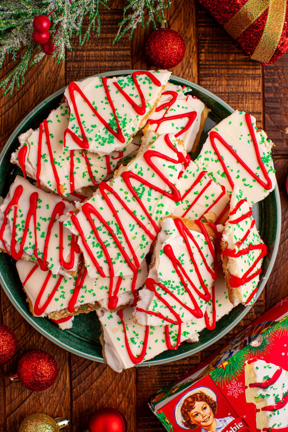 Christmas Tree Crack on a plate with holiday decor around the plate 