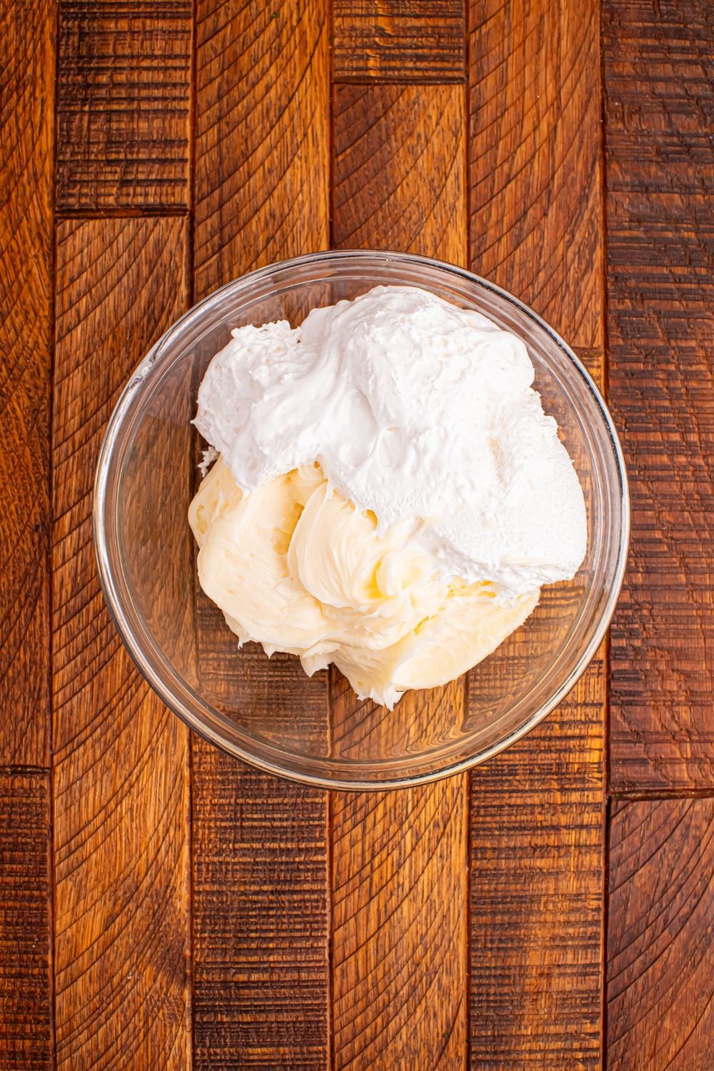 cream cheese frosting and marshmallow fluff in a bowl on wooden table for Christmas Tree Crack