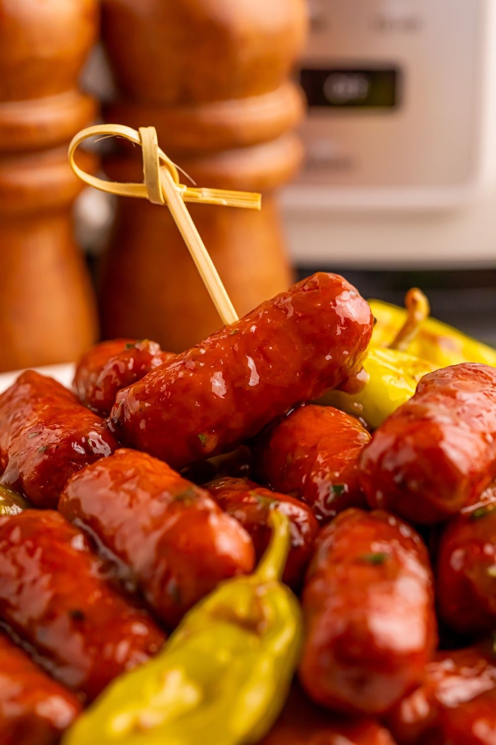 cocktail sausages stacked on table with peppers