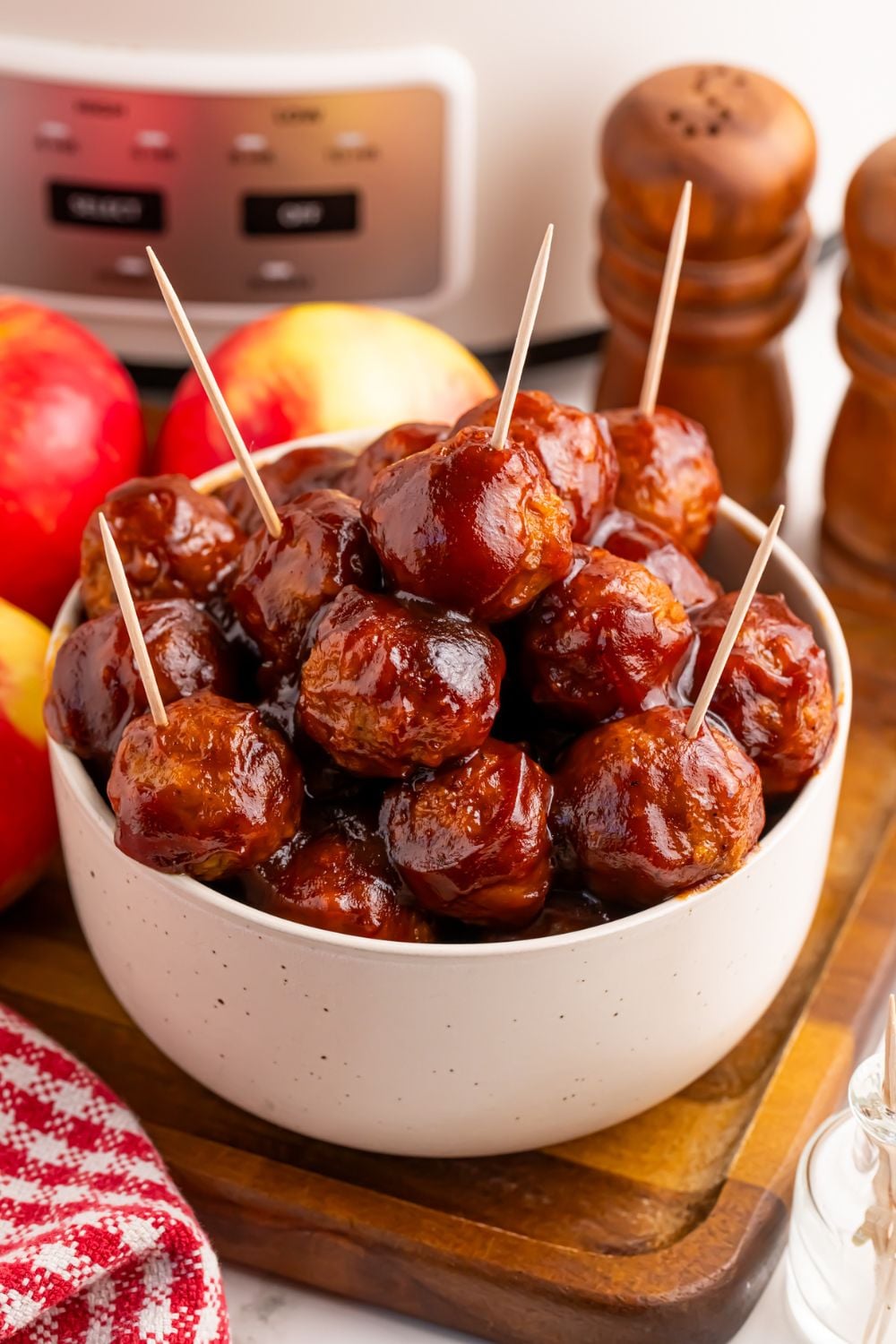 Crockpot Apple Butter Meatballs in a bowl on table with a few toothpicks in for serving as an appetizer
