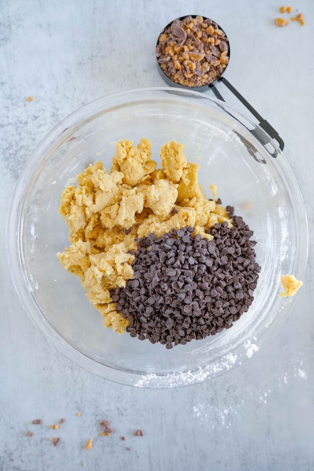 chocolate chip cookie dough with a bunch of chocolate chips on top of cookie dough