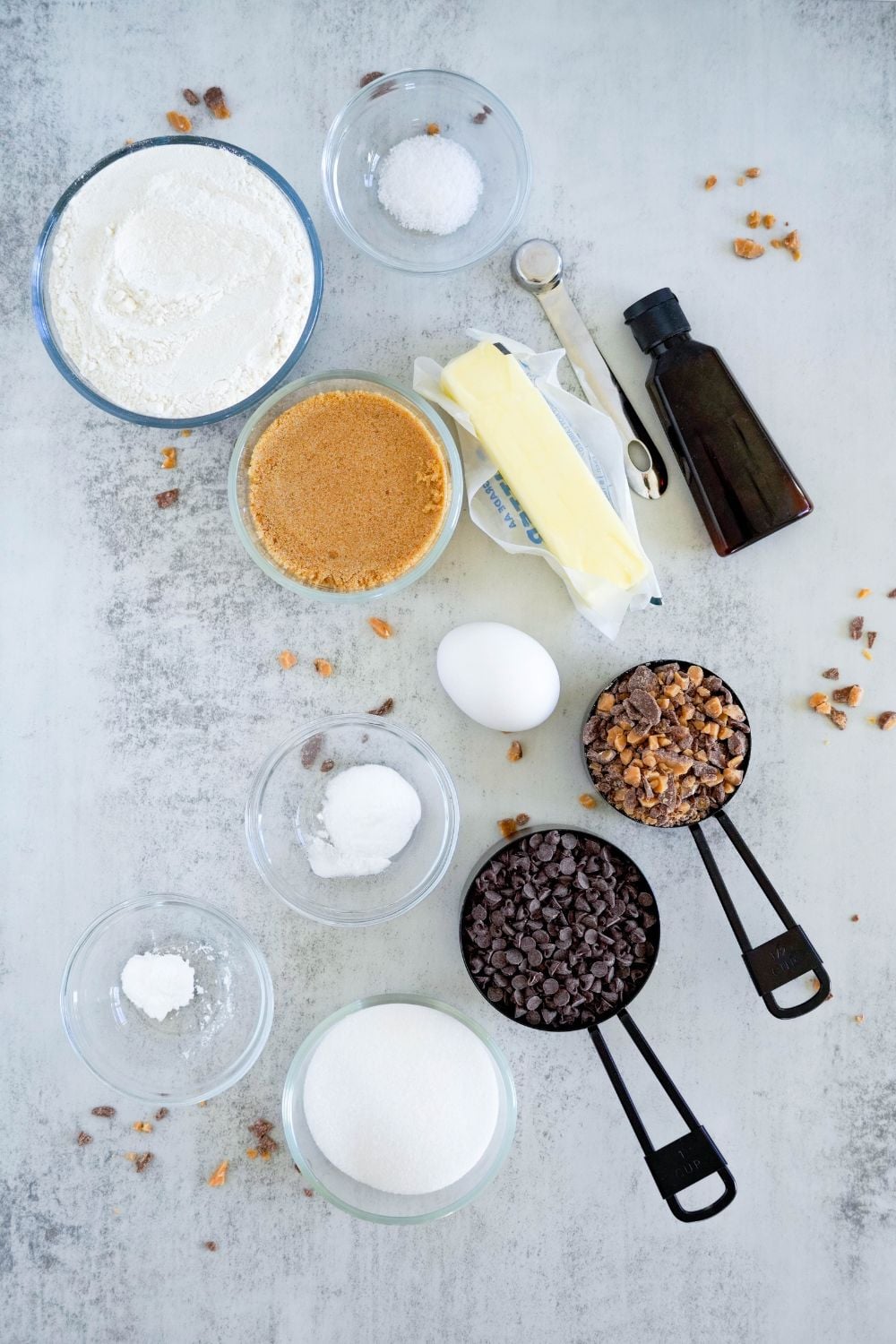 ingredients for Chocolate Chip Toffee Cookies on counter with ingredients in single serve containers