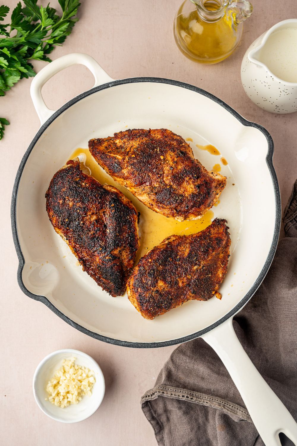 blackened chicken being pan seared in a skillet 