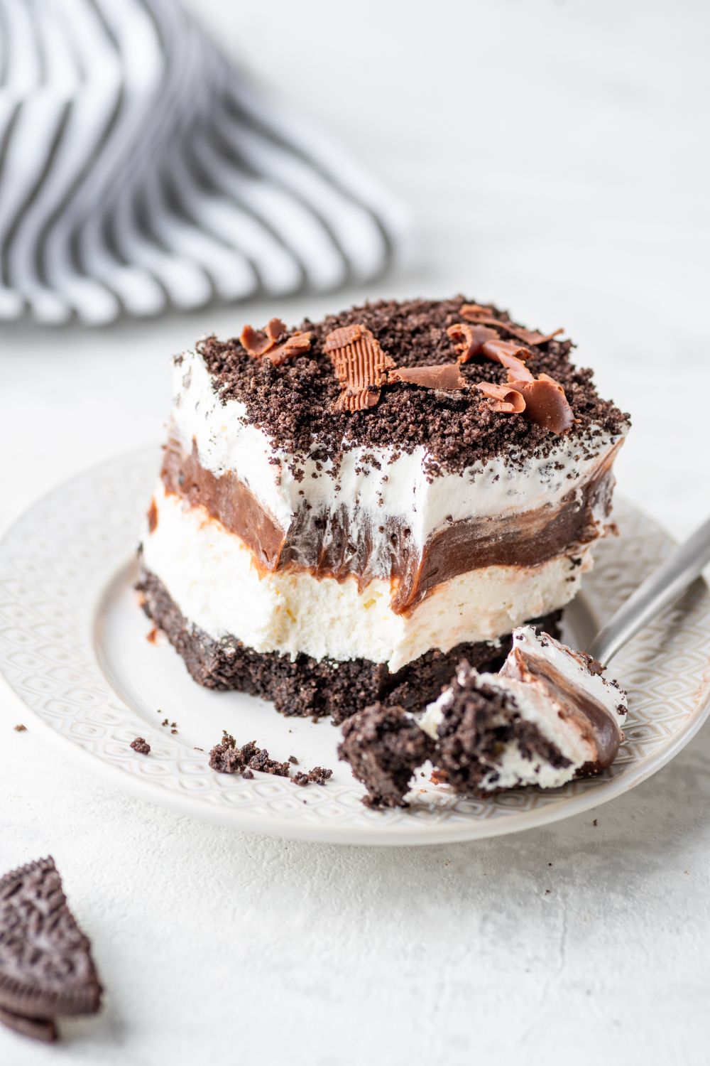 Chocolate Oreo Lush on a plate with a bite sitting on the fork 
