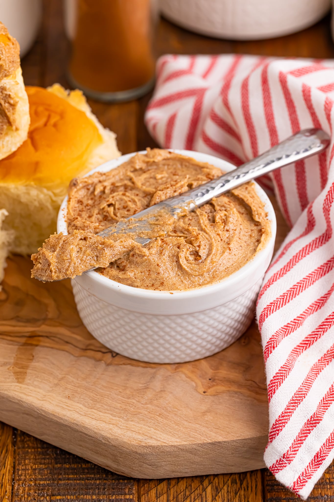 Brown Sugar Cinnamon Butter in a small container on table with a knife on top of bowl