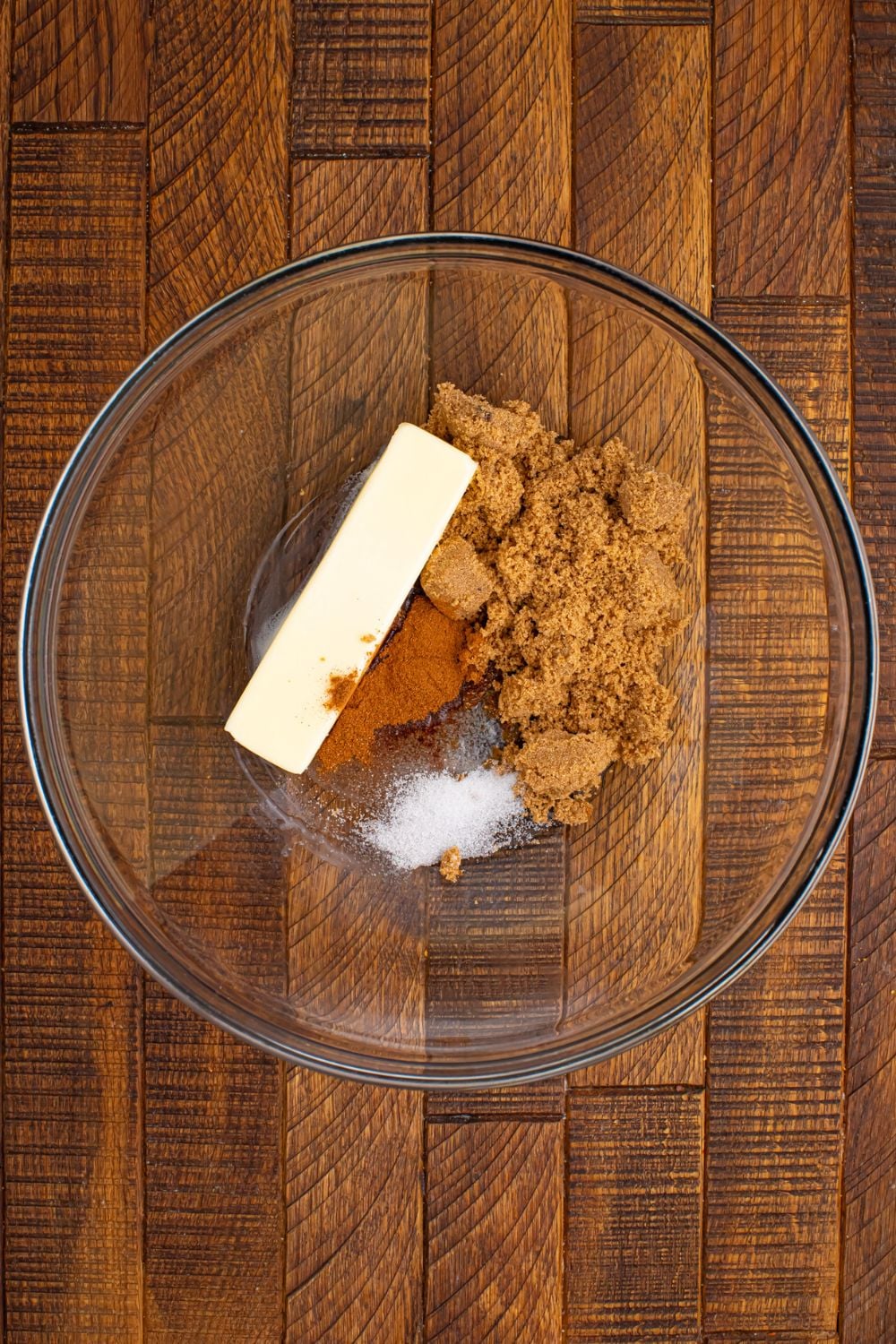 glass bowl with butter, brown sugar, cinnamon and salt in it