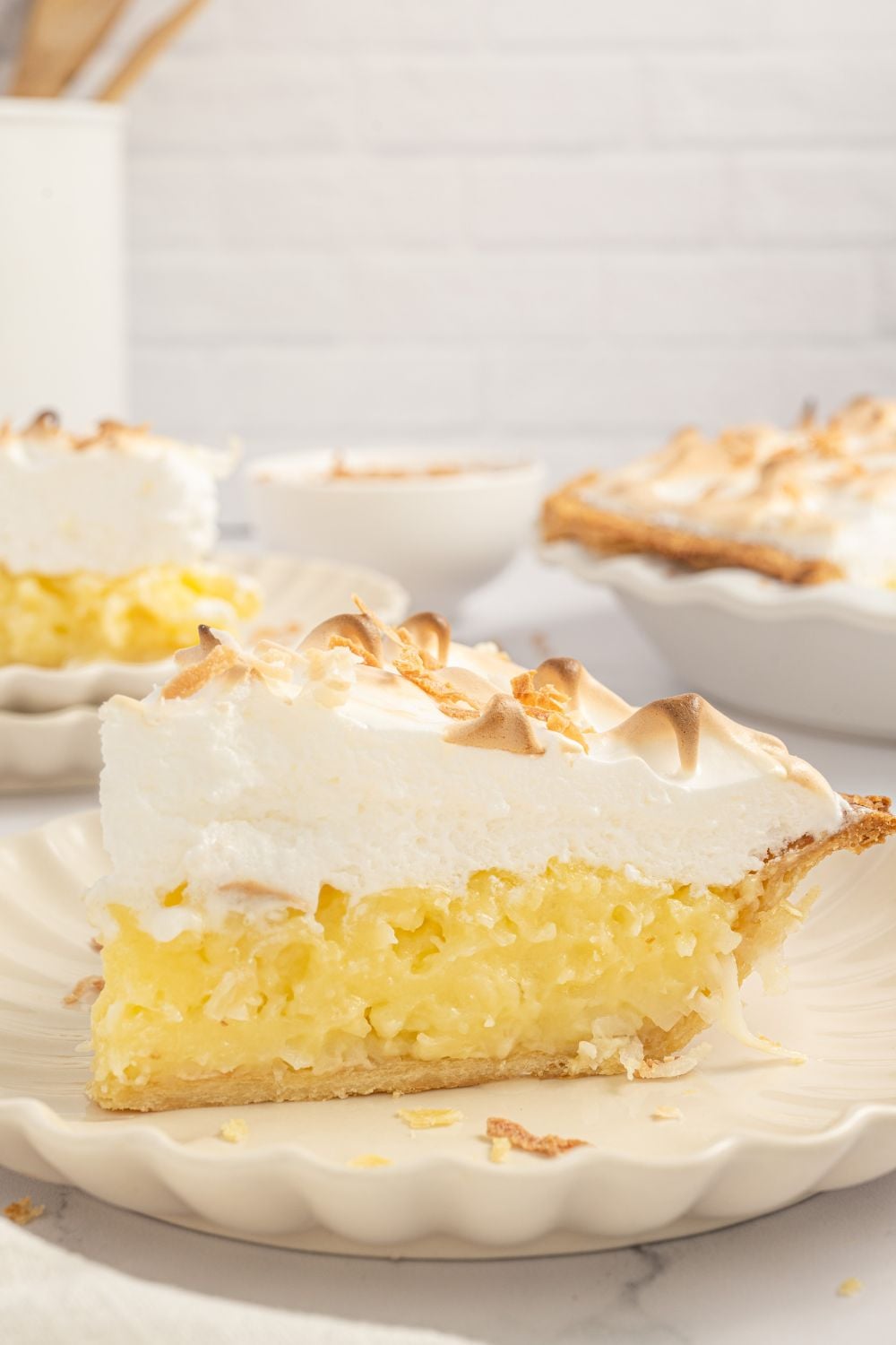 Coconut Meringue Pie sliced on plates 