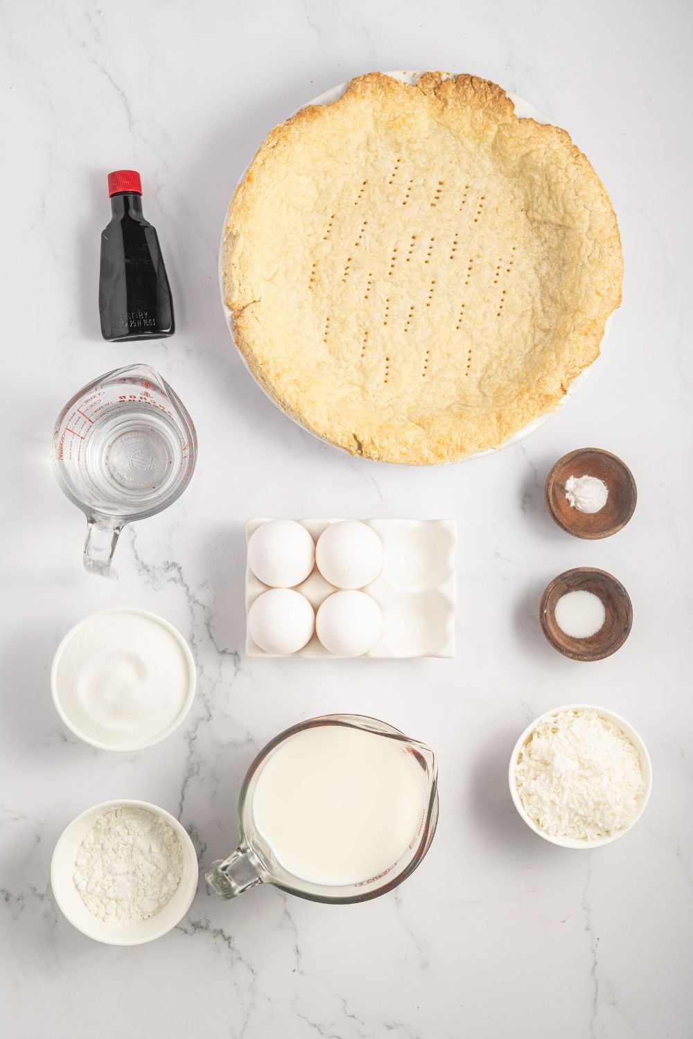 ingredients for Coconut Meringue Pie in single serve containers on table 