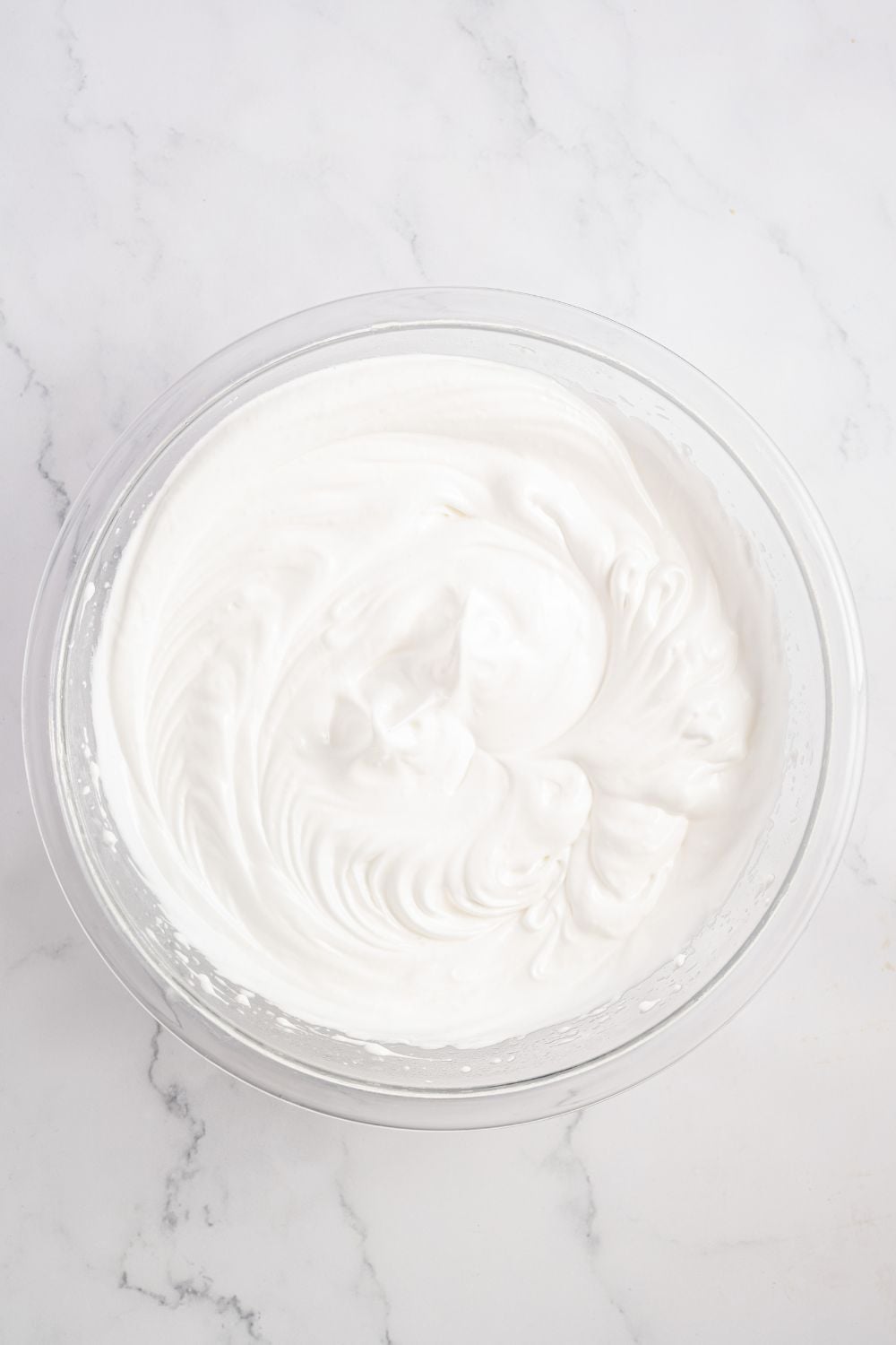 meringue in a glass bowl on table