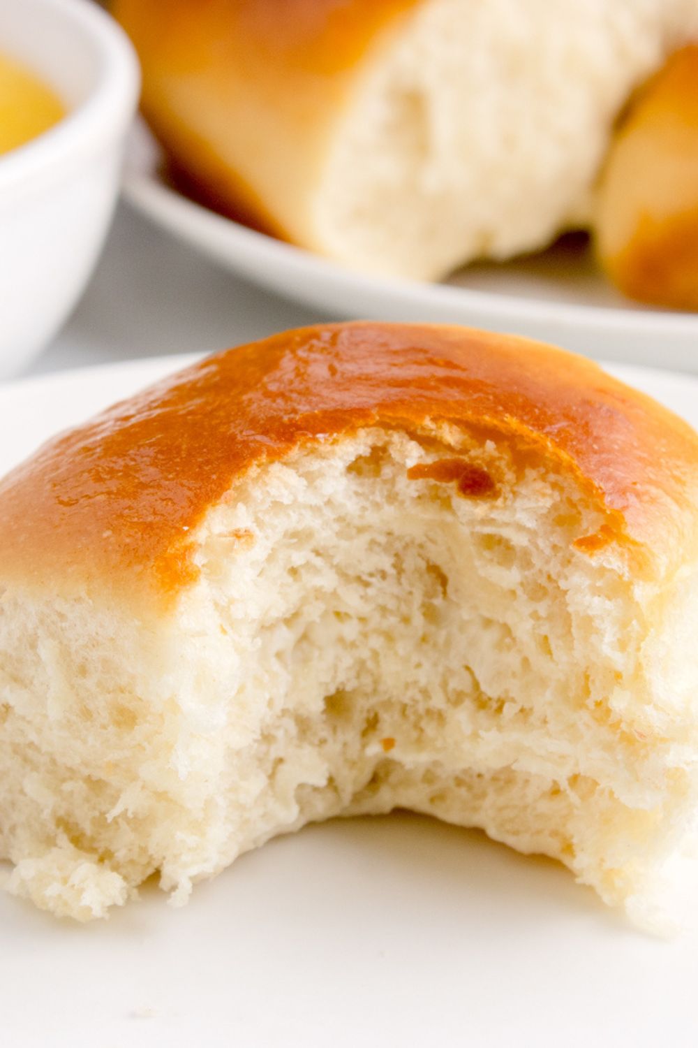 Hawaiian Dinner Roll on plate with a bite taken out of it