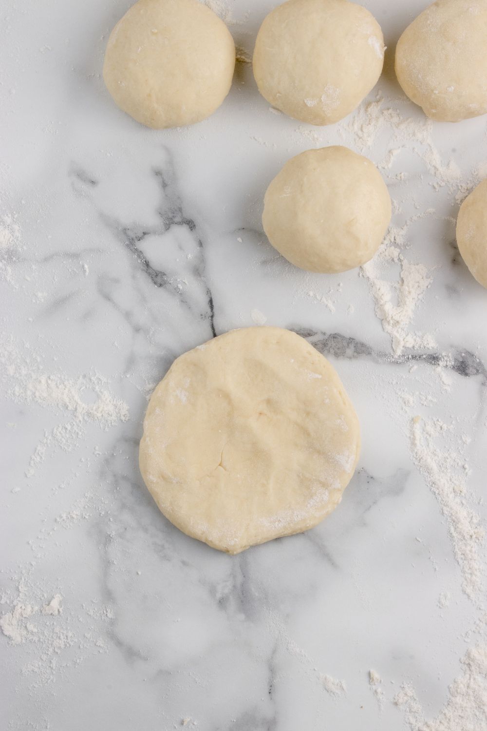 round dough for making rolls on table