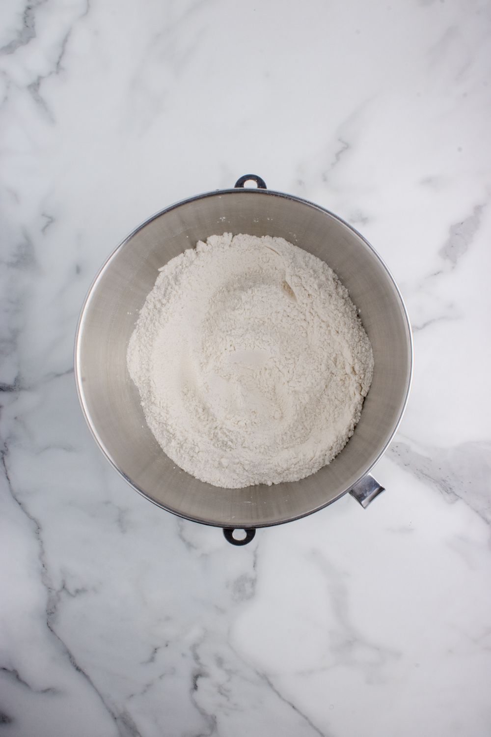 flour in a mixing bowl on table for making Hawaiian rolls