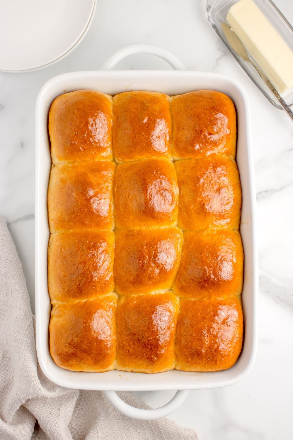 buttery baked pull apart rolls in casserole pan on table