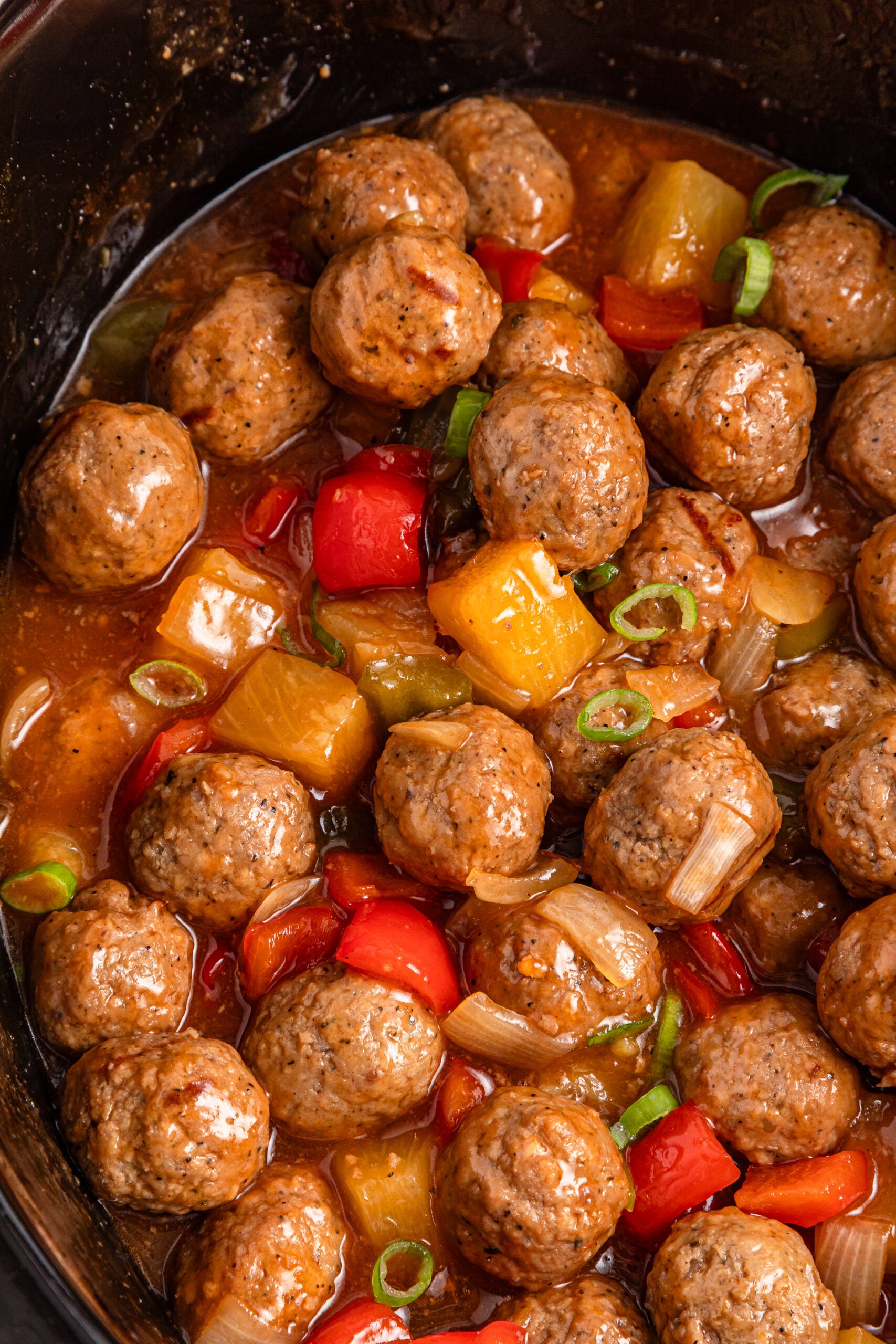 Up close shot of the crock pot sweet and sour meatballs in a crock pot