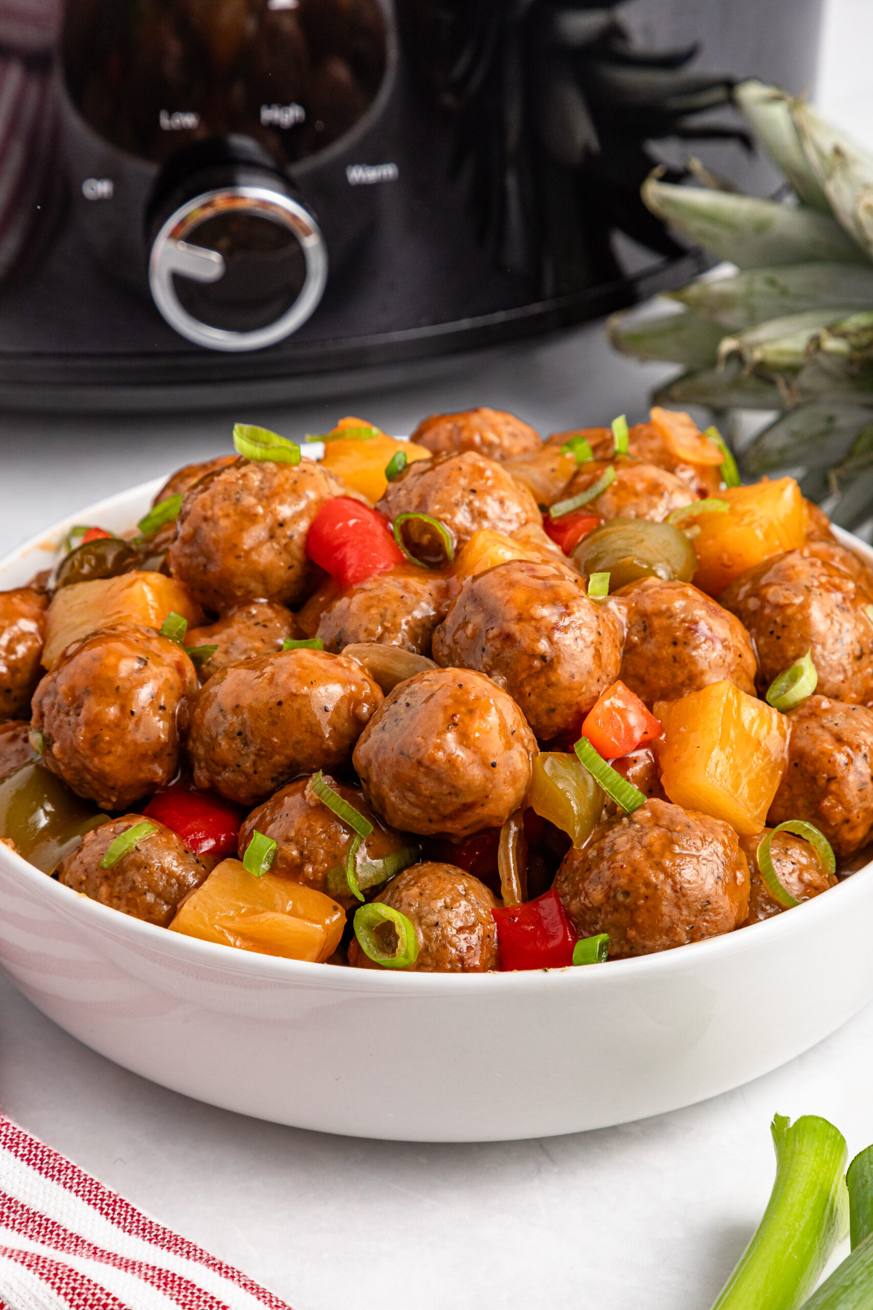 Crock Pot Sweet And Sour Meatballs in a large white serving bowl