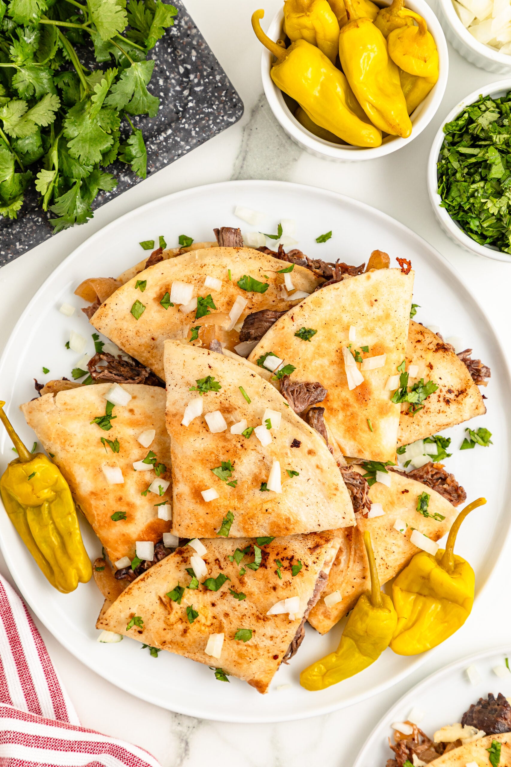 overhead shot of the Mississippi Pot Roast Quesadillas piled on a white plate