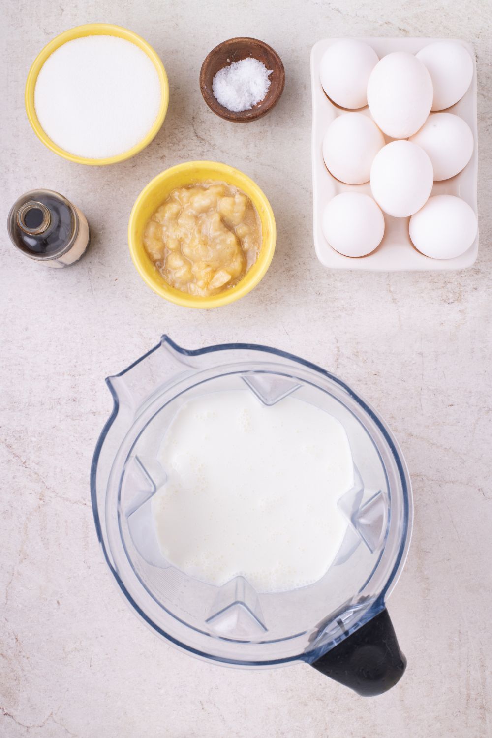 ingredients for Banana Bread Pudding in bowls and a mixer on table