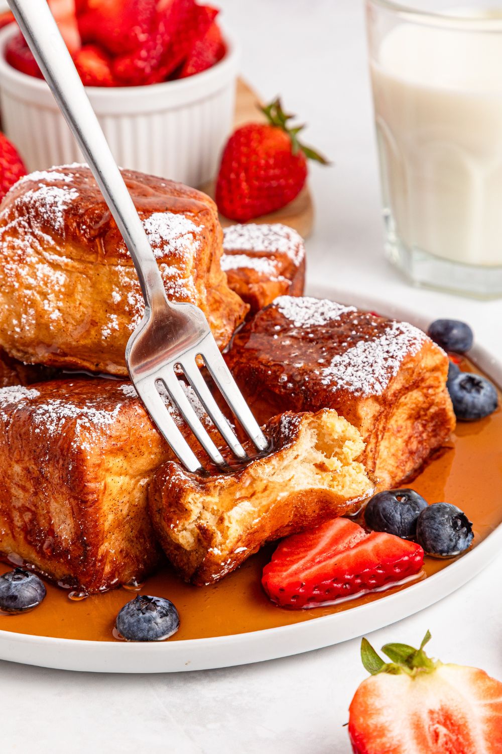 fork poking in one of the Hawaiian Roll French Toast on plate 