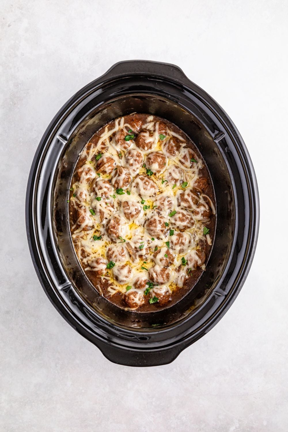 cooked Crock Pot French Onion Meatballs in a crockpot on table