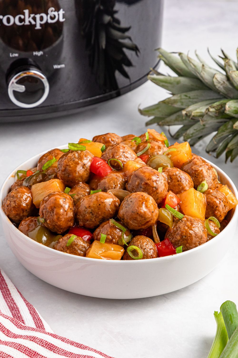 Crock Pot Sweet And Sour Meatballs in a white bowl on table