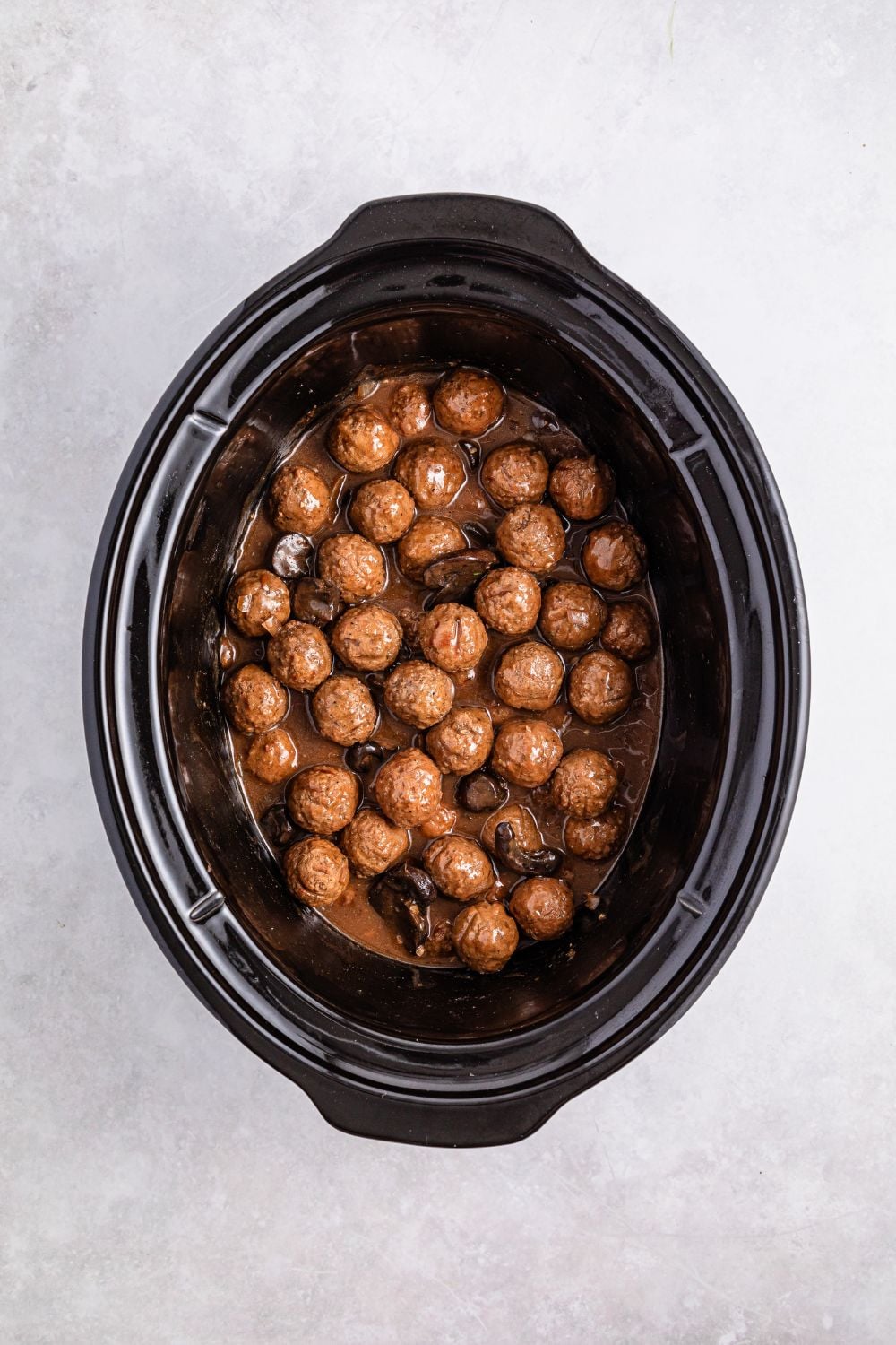 Crock Pot Salisbury Steak Meatballs in a crock pot on white table