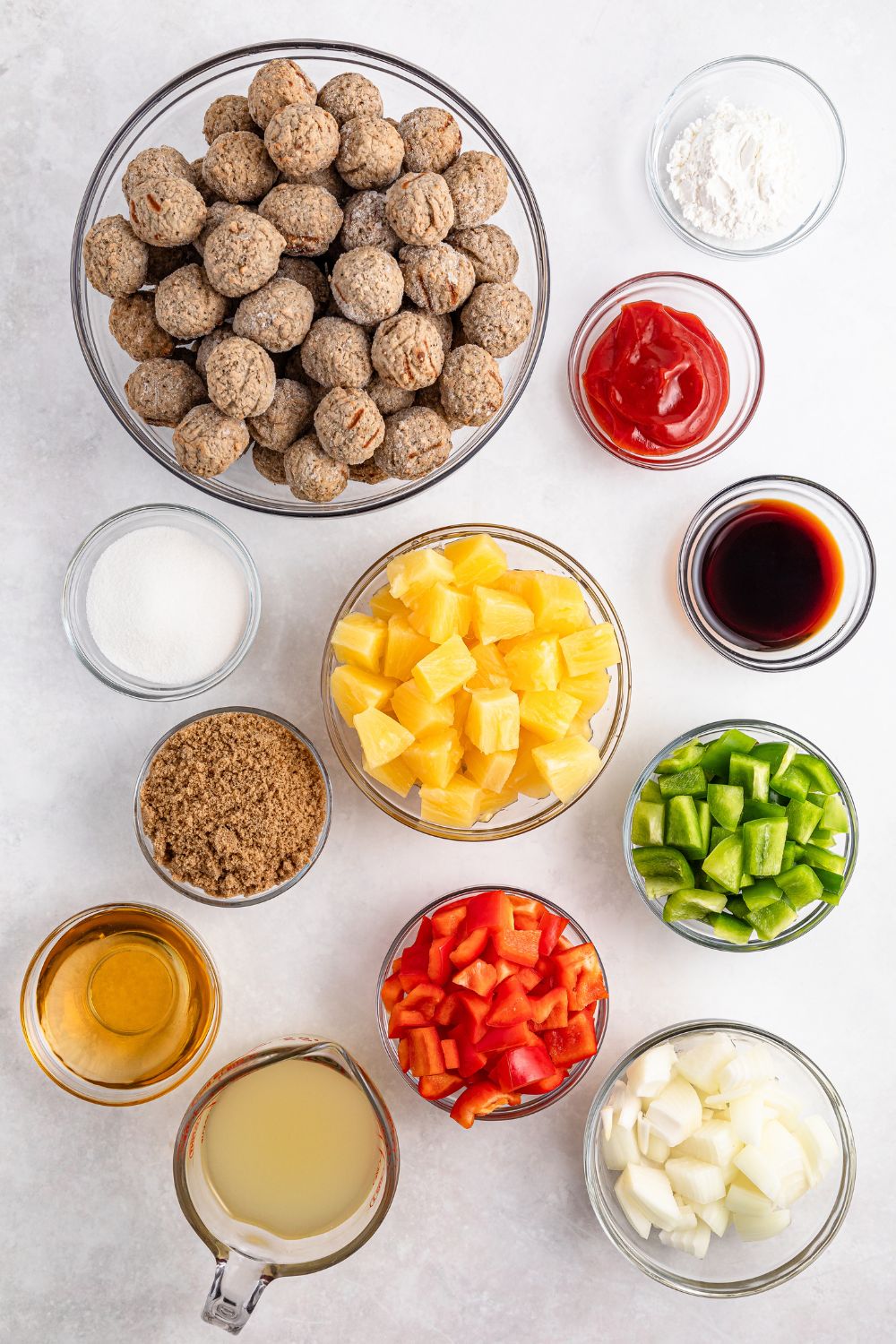 ingredients for sweet and sour meatballs in single serve containers on table