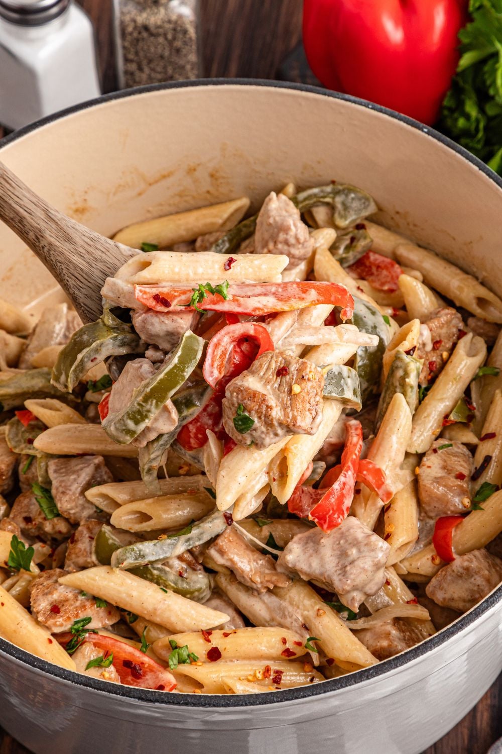 cooked Rasta Pasta in a stockpot with some scooped out with a wooden spoon