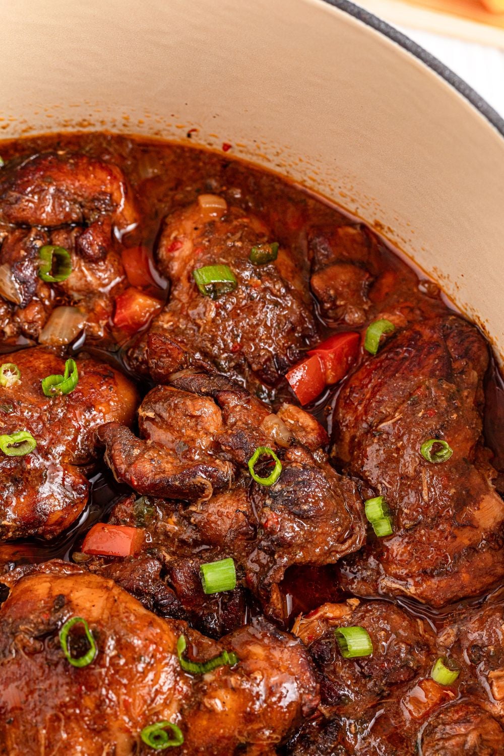 Jamaican Brown Stew Chicken in a pot close up view of meat