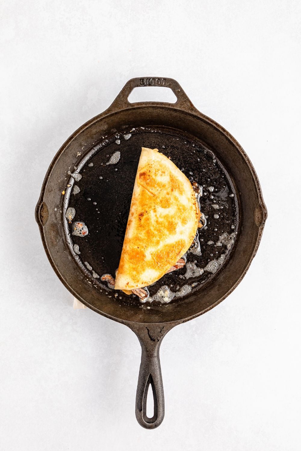 skillet with a Mississippi Pot Roast Quesadilla in it