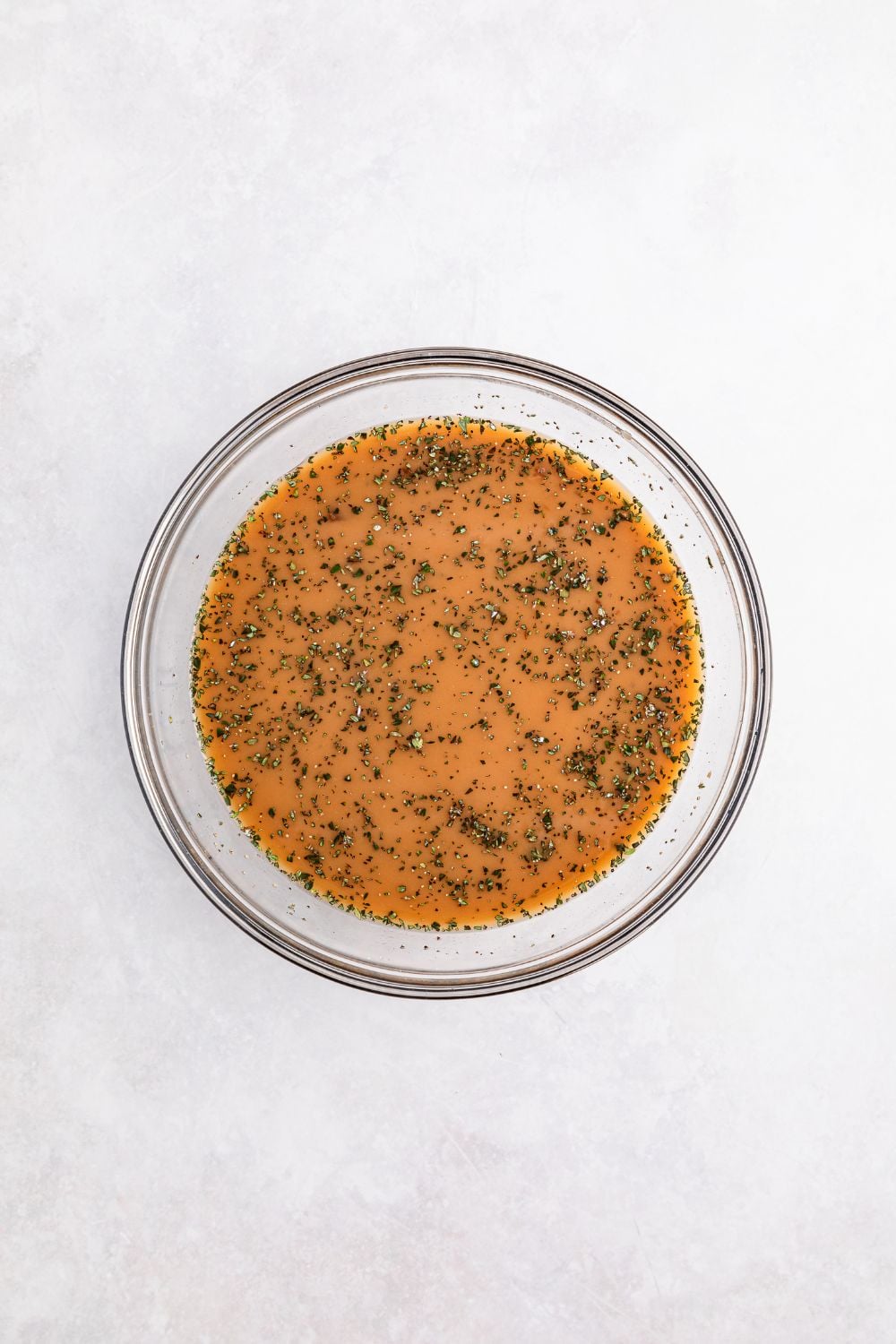sauce in a glass bowl for making Crock Pot French Onion Meatballs