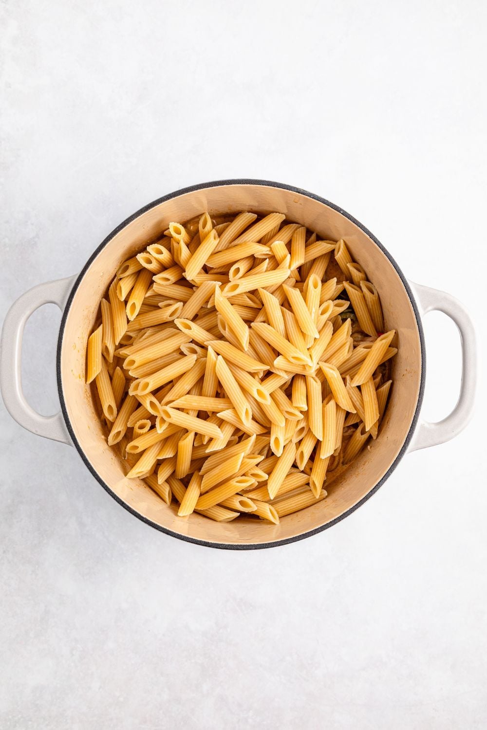 uncooked pasta in a stockpot on table