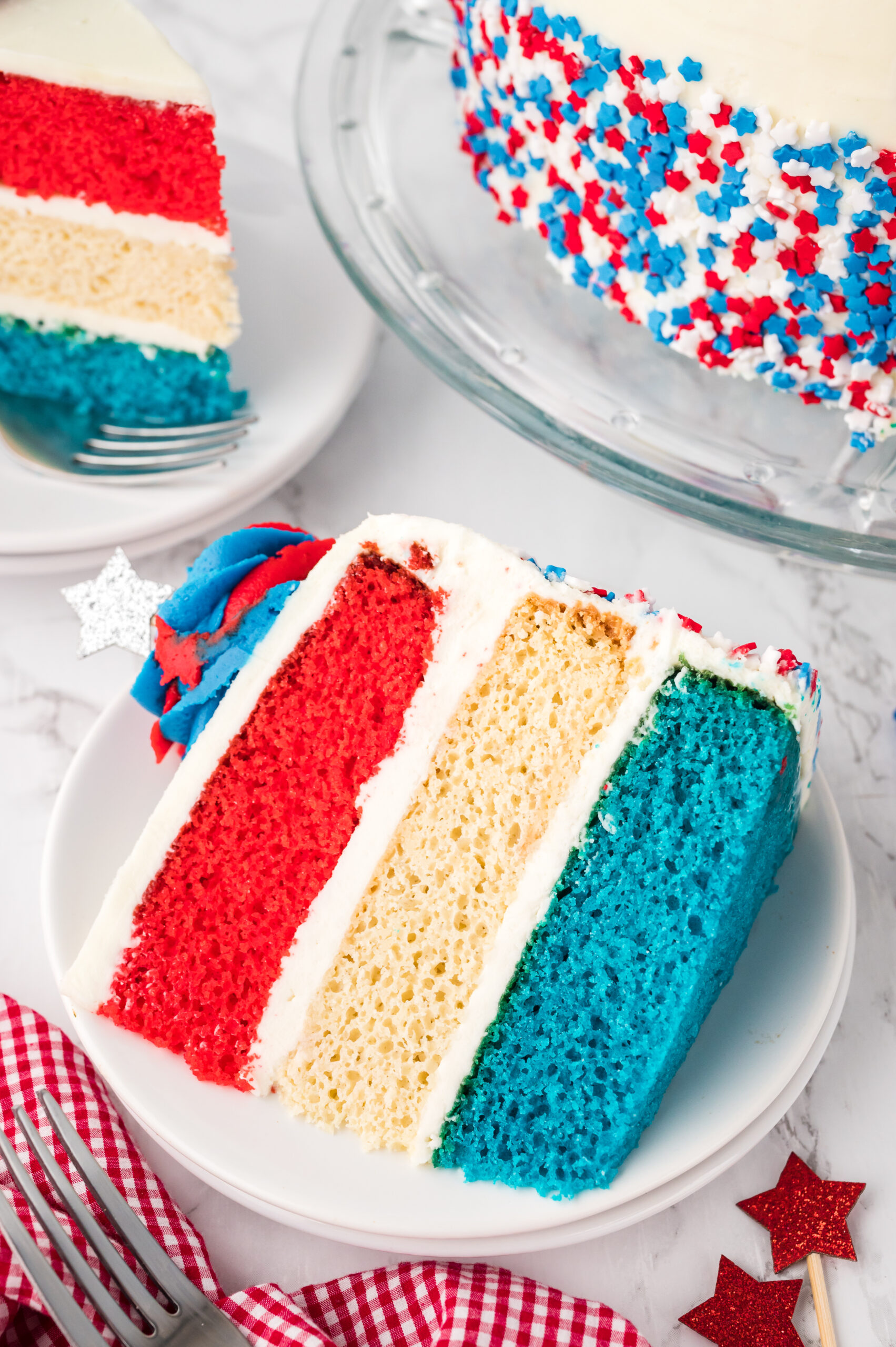 overhead shot of a Slice of American Flag Layered Cake on a white plate 