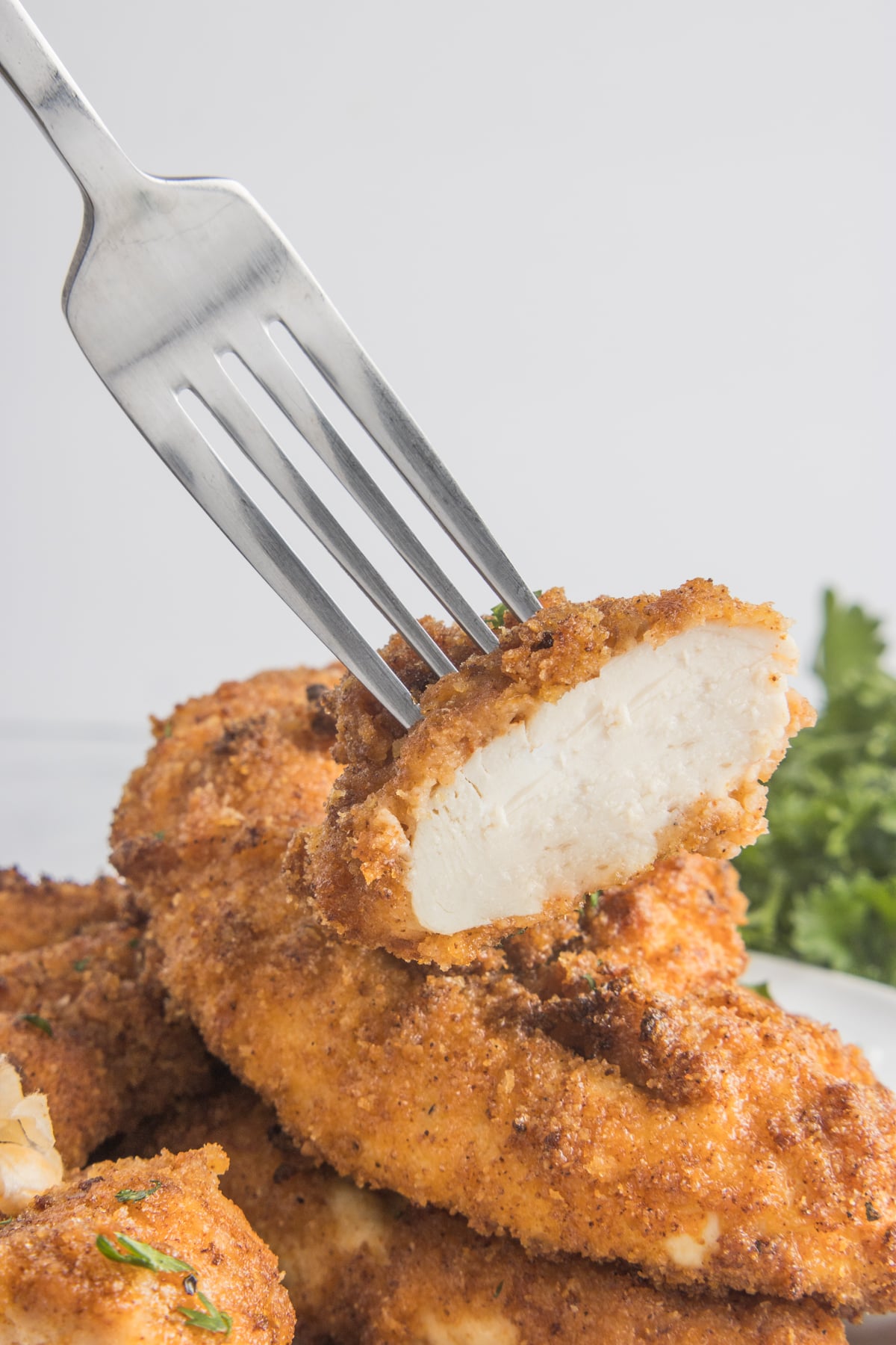 Fork lifting up a bite of the Air Fryer Chicken Tender