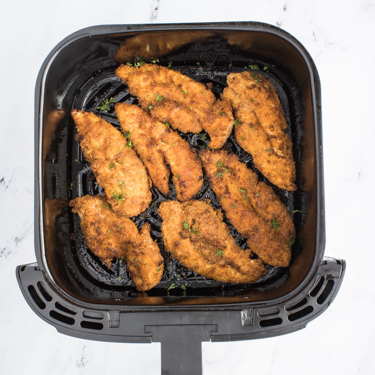 Air Fryer Chicken Tenders cooked inside the air fryer basket