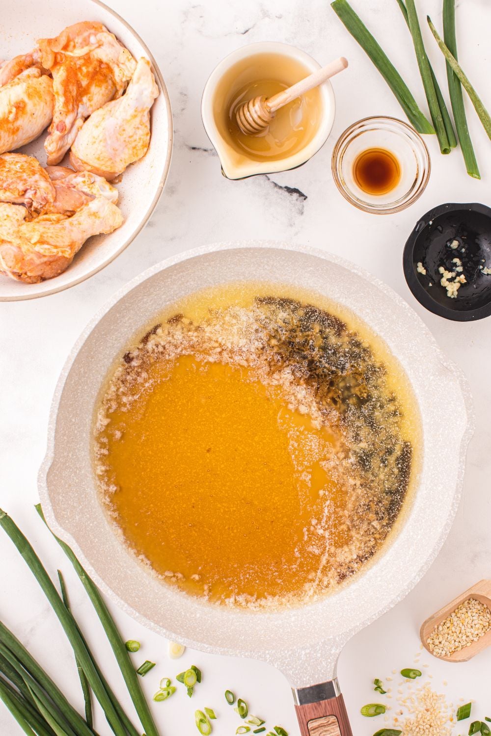 honey garlic sauce in a bowl with more ingredients to add into the small bowl 