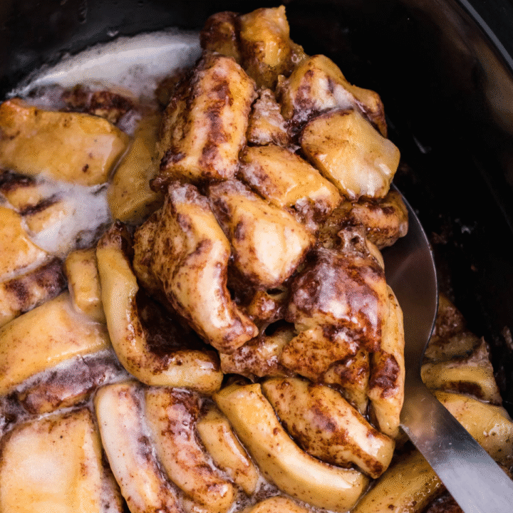 Close up view of the Cinnamon Roll Casserole being served using a large silver spoon