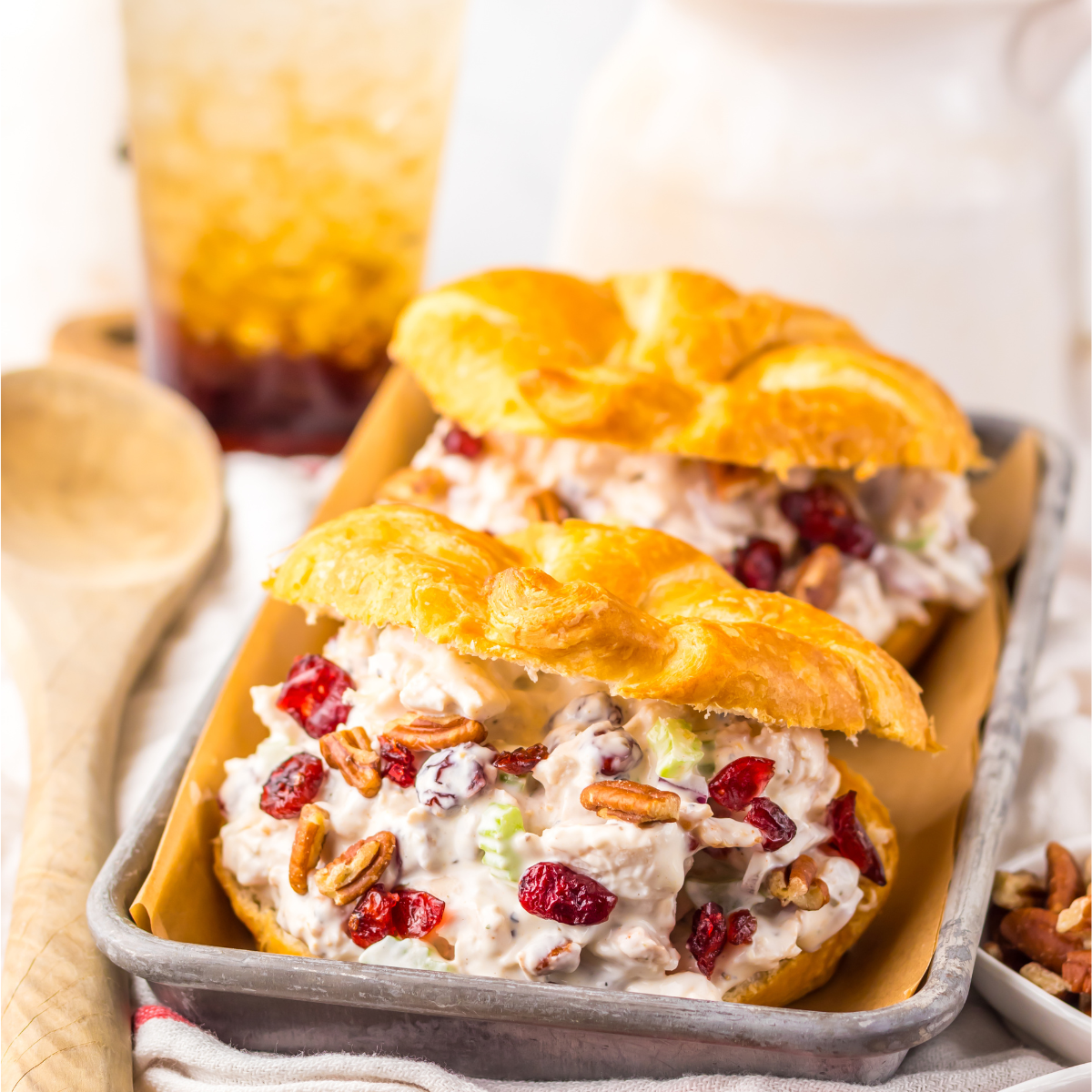 Close up of the chicken salad croissant filling topped with cranberries and pecans.