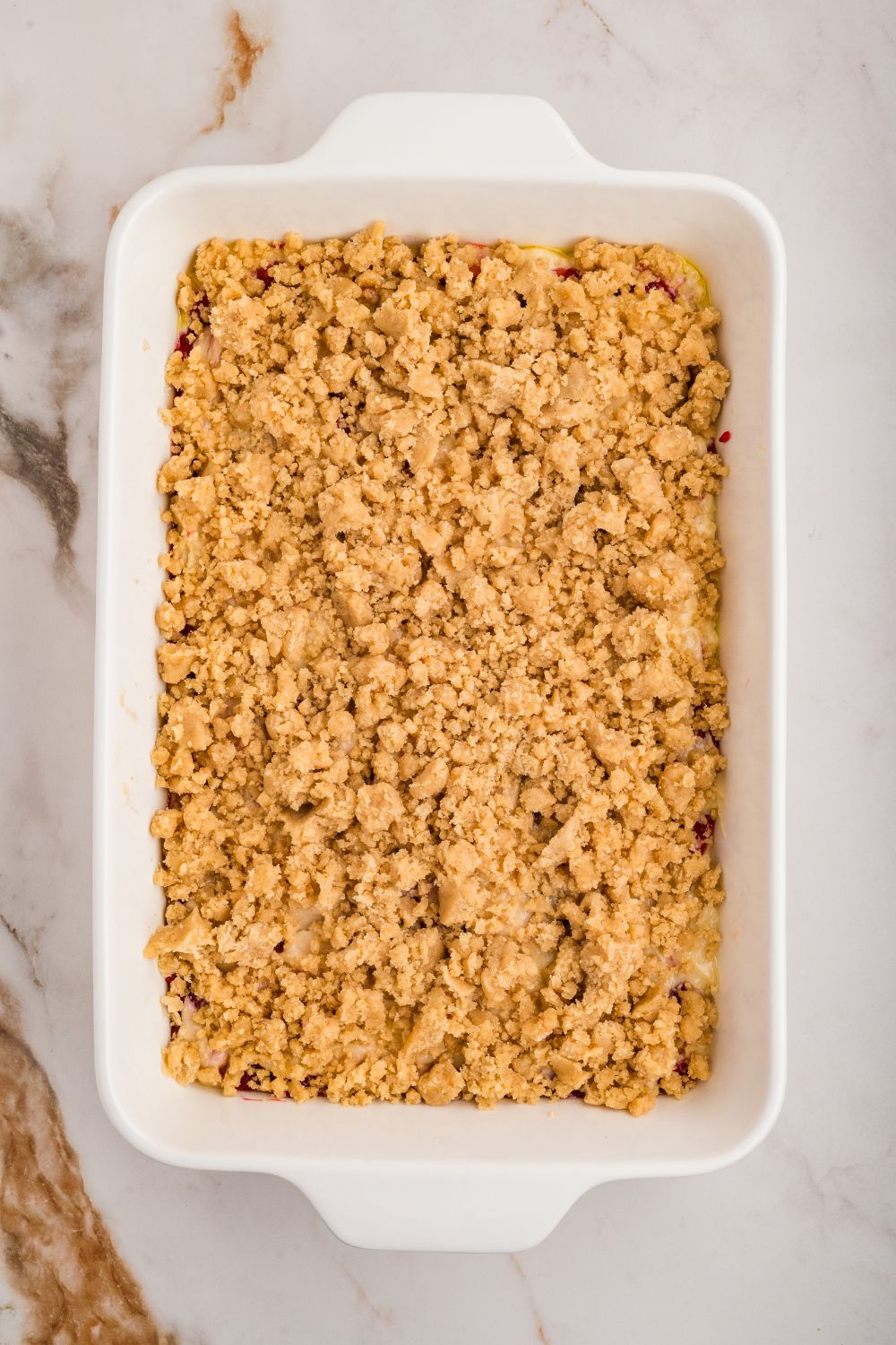 overhead shot of pan with crumble on top for the Strawberry Coffee Cake