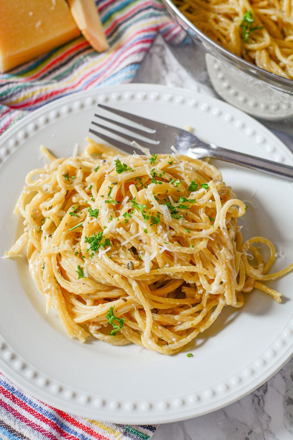 circle of Garlic Parmesan Pasta on plate with fork to side of plate