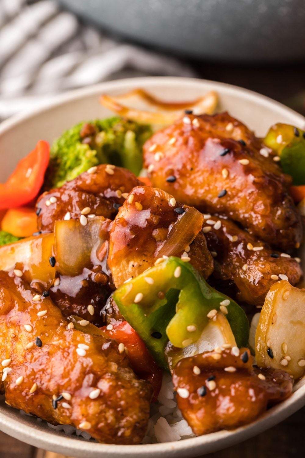 General Tso Chicken in a bowl with a towel on side