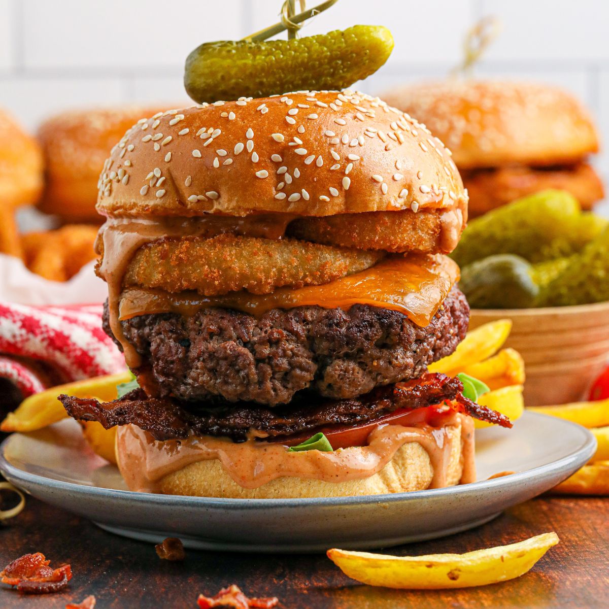 Cowboy Burger on plate that is fully loaded with toppings