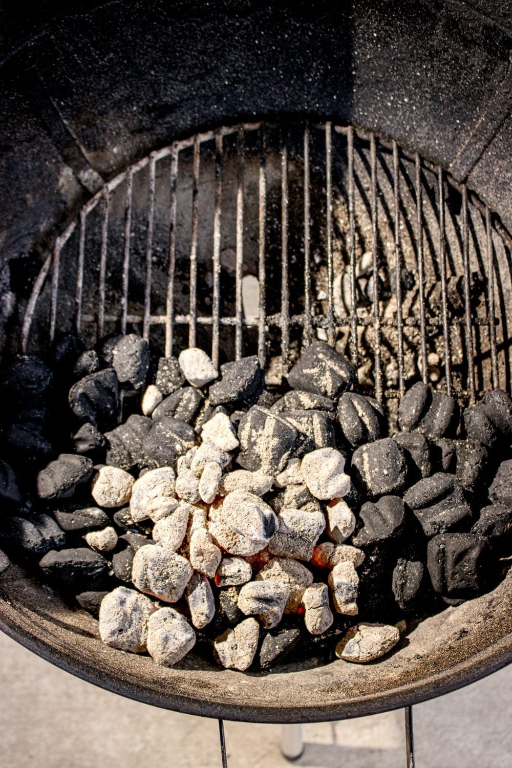 charcoal grill with some coals burned down