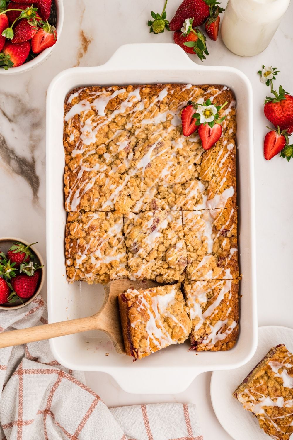 Strawberry Coffee Cake in pan with a slice taken out of it