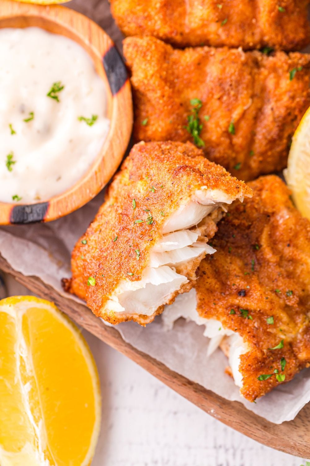 Air Fryer Fish And Chips on platter with tartar sauce in a small bowl