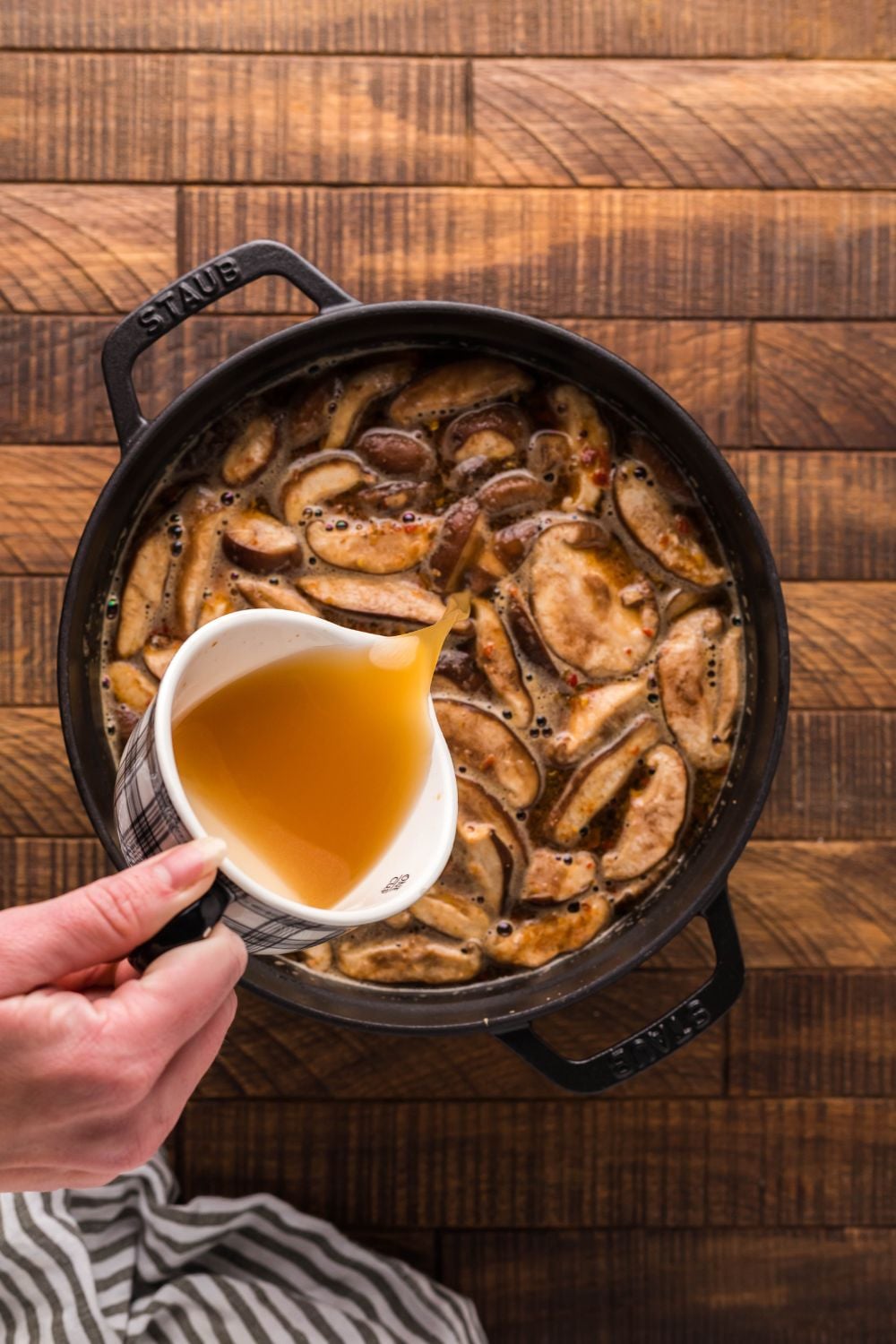 broth being poured into pot for making PF Changs Hot And Sour Soup